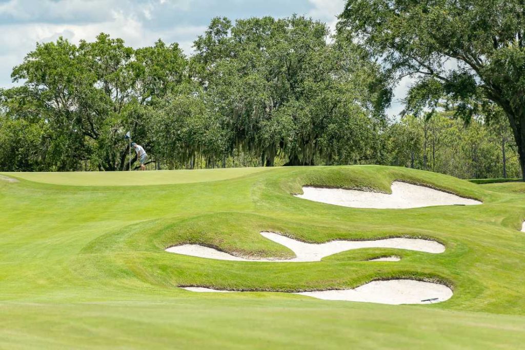 A picturesque view of Camp Creek's diverse holes designed by Tom Fazio, showcasing the integration with the natural landscape.